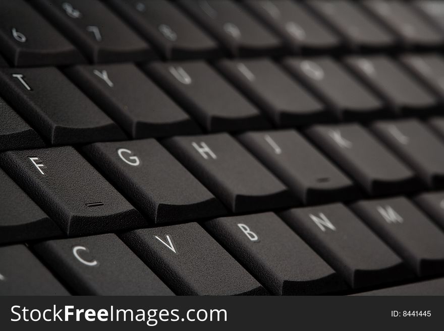 Black laptop keyboard selective focus. Black laptop keyboard selective focus
