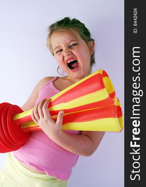 Girl is holding a horn in her hands. Girl is holding a horn in her hands