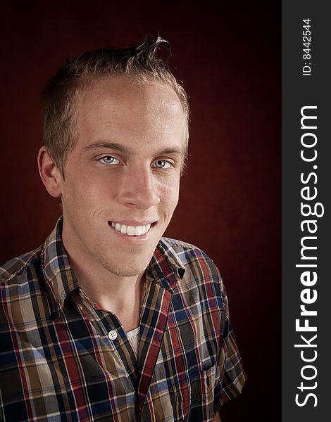 Portrait of handsome young blonde man in plaid shirt. Portrait of handsome young blonde man in plaid shirt