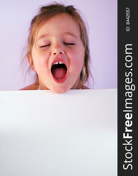 A girl is holding a frame in her hands. A girl is holding a frame in her hands