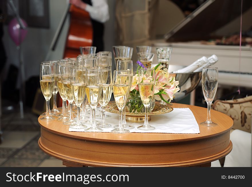 Many champagne glasses in fine restaurant on a table with live music on background. Many champagne glasses in fine restaurant on a table with live music on background