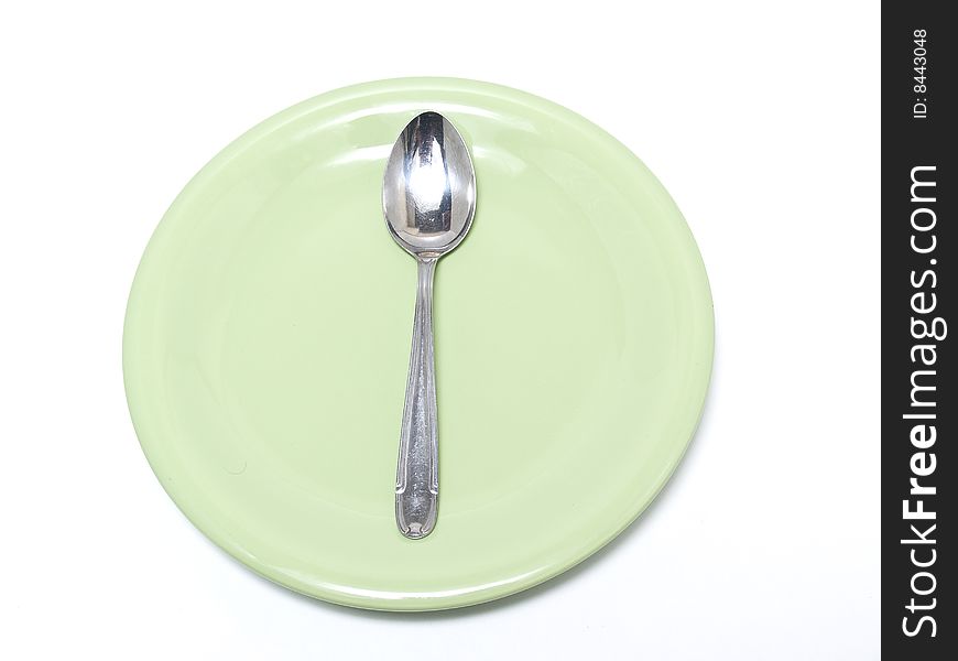 Plate and spoon photograph in the foreground on a white background