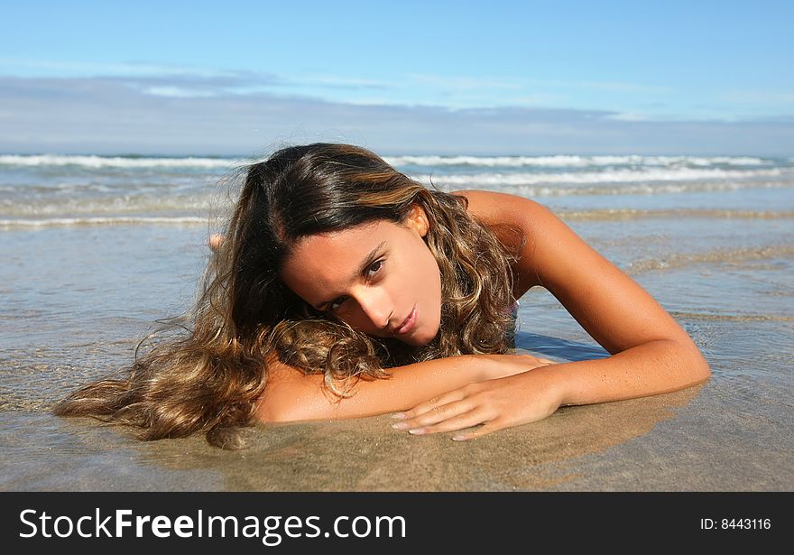 Beautiful woman lays on beach