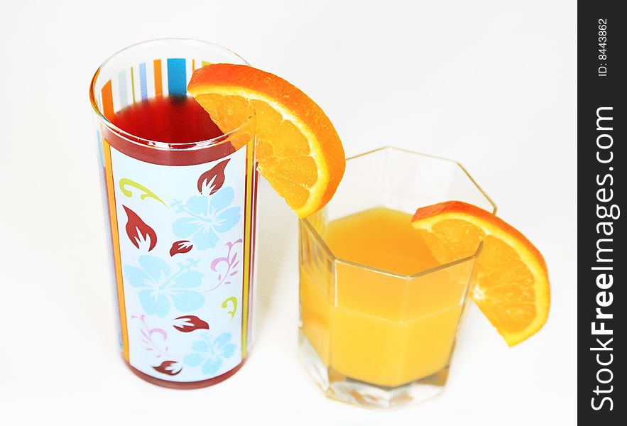 Orange juice in two glasses isolated over white