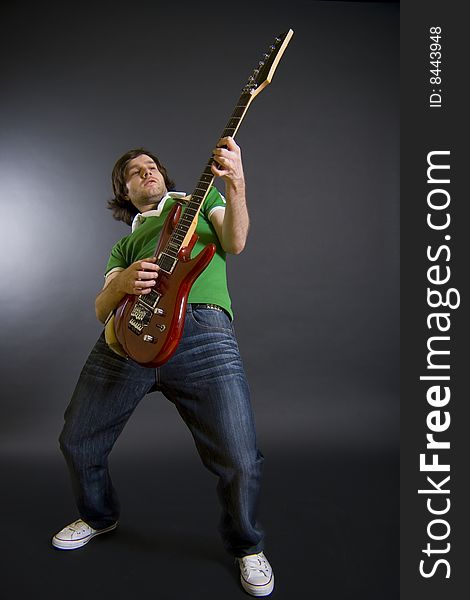 Passionate guitarist playing his electric guitar