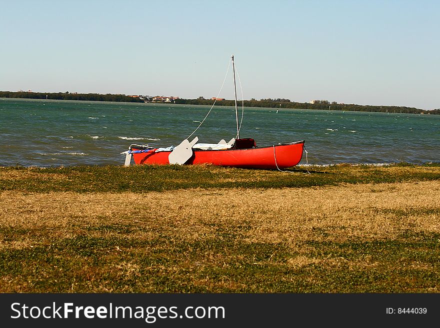 A red canoe on the shores of the Florida Gulf Coast