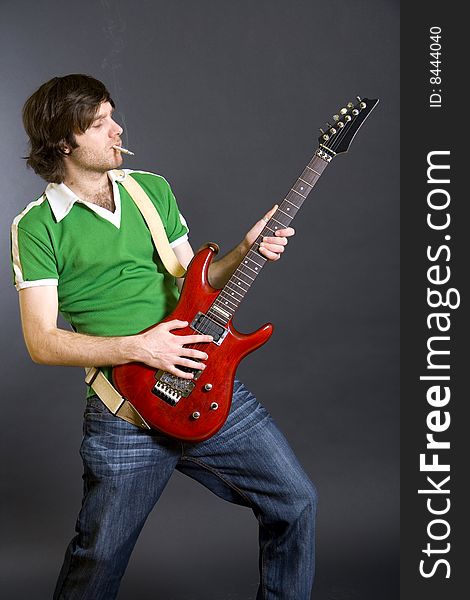 Passionate guitarist playing his electric guitar