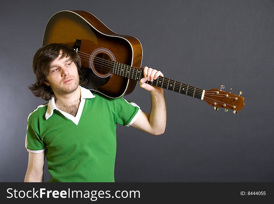 Guitarist with an acoustic guitar on shoulder