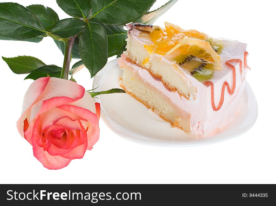 Piece of cake and rose, isolated on white