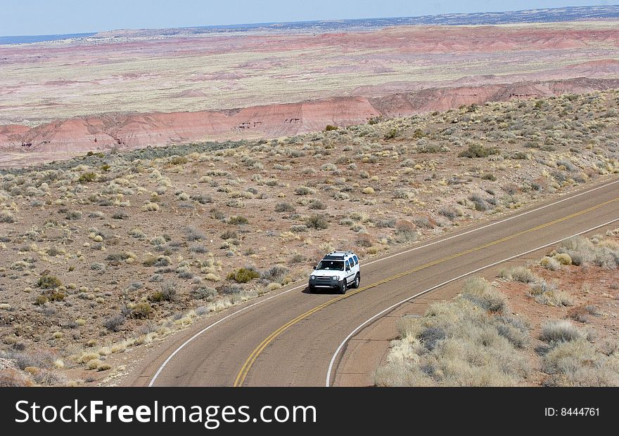 SUV driving on winding desert road. SUV driving on winding desert road