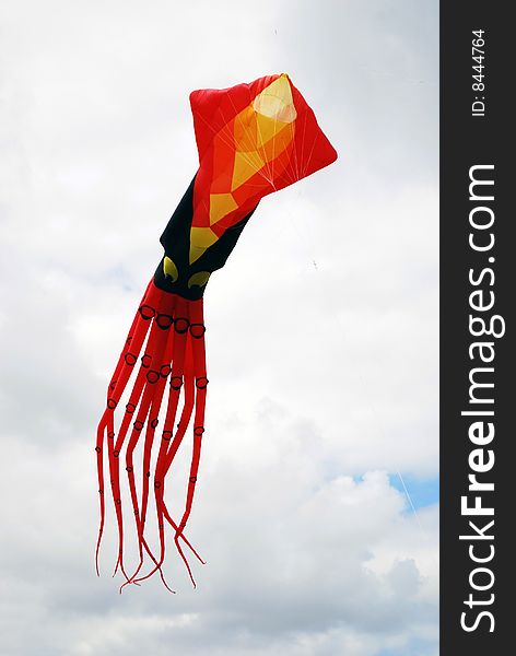 A stylized octopus kite fllying high over a beach in southeast florida