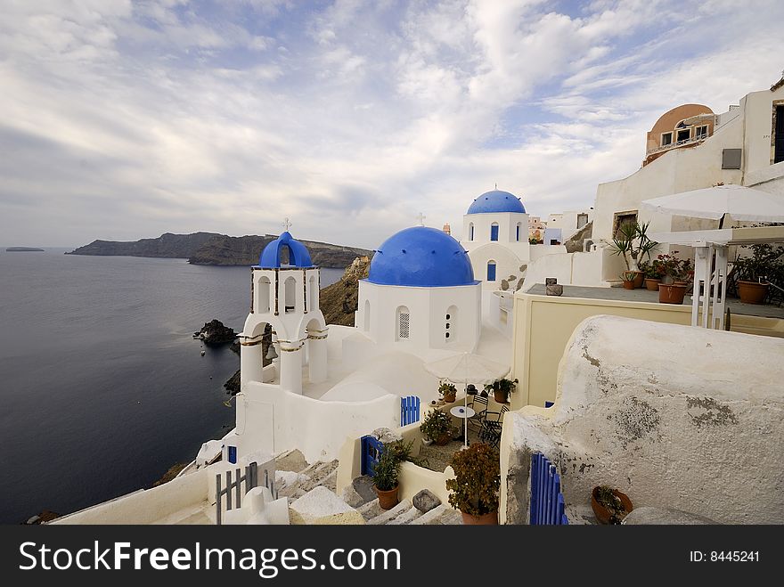 Oia remains one of the foremost tourist attractions of the Aegean Sea. This picture White church against blue sea in Santorini, Greece. Oia remains one of the foremost tourist attractions of the Aegean Sea. This picture White church against blue sea in Santorini, Greece.