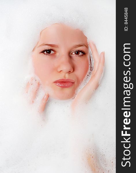 Face of a beautiful woman in white foam. Face of a beautiful woman in white foam