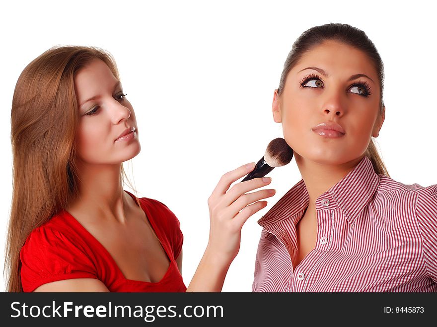 Two beautiful woman with brush for make-up