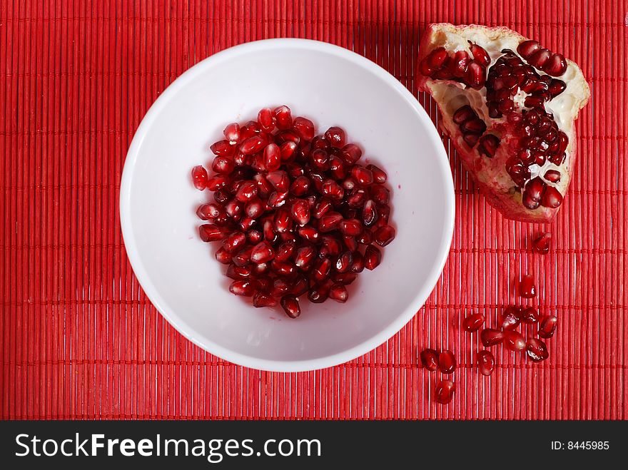 Red seeds and white bowl