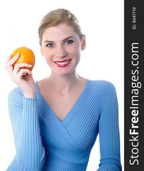 Portrait of the beautiful girl with an orange in hands