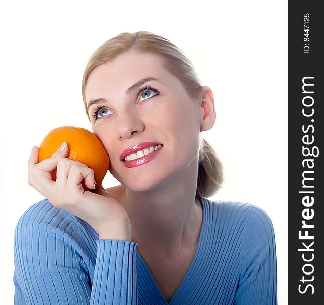 Portrait of the beautiful girl with an orange in hands