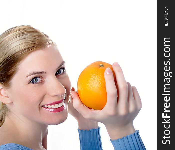 Portrait of the beautiful girl with an orange in hands