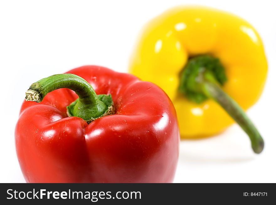 Red and yellow pepper over white. Red and yellow pepper over white