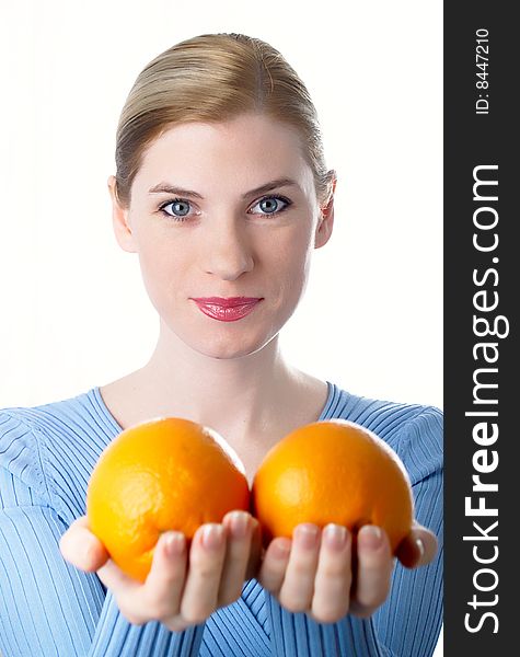 Portrait of the beautiful girl with an orange in hands