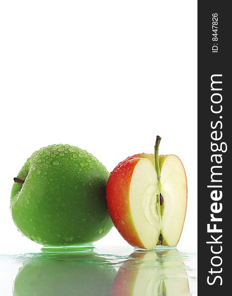 Green apple and slice of red apple