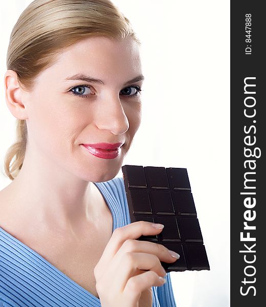 Portrait of the beautiful girl with a chocolate in a hand