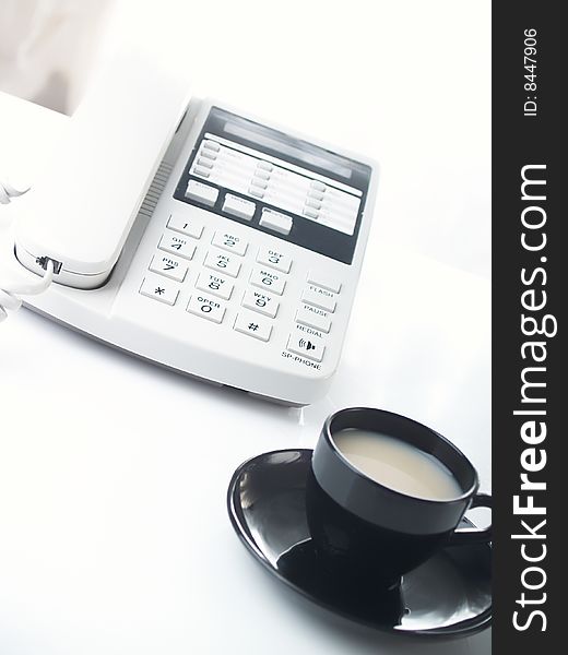 Modernwhite business office telephone and cup