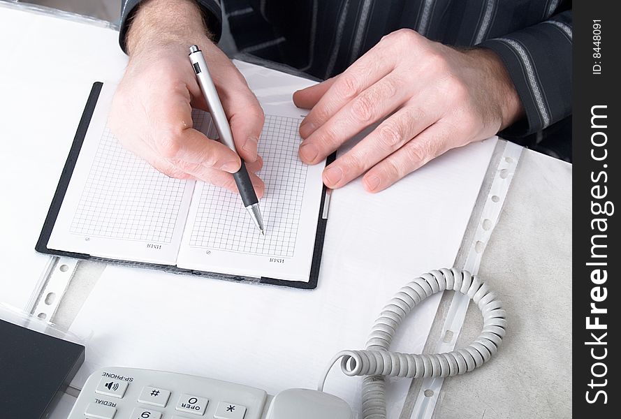 Closeup of mans hand going to write a business plan. Closeup of mans hand going to write a business plan