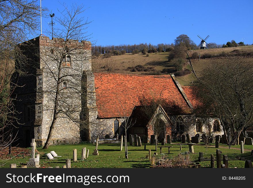 St. Mary's Church at Turville in south Buckinghamshire England. The windmill in the background was featured in the film 'Chitty Chitty Bang Bang'. St. Mary's Church at Turville in south Buckinghamshire England. The windmill in the background was featured in the film 'Chitty Chitty Bang Bang'.