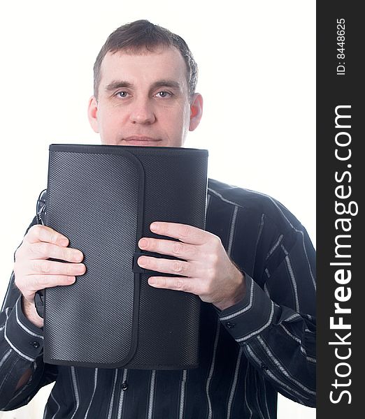 Portrait of the businessman in a dark shirt with a portfolio at office. Portrait of the businessman in a dark shirt with a portfolio at office
