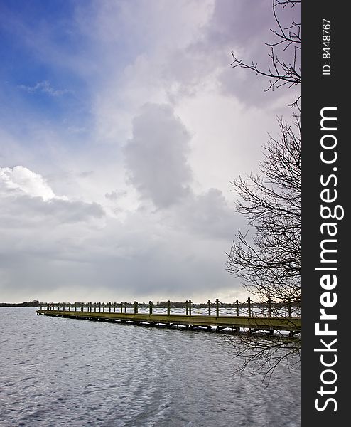 Lakeside jetty over a deep blue sky. Lakeside jetty over a deep blue sky