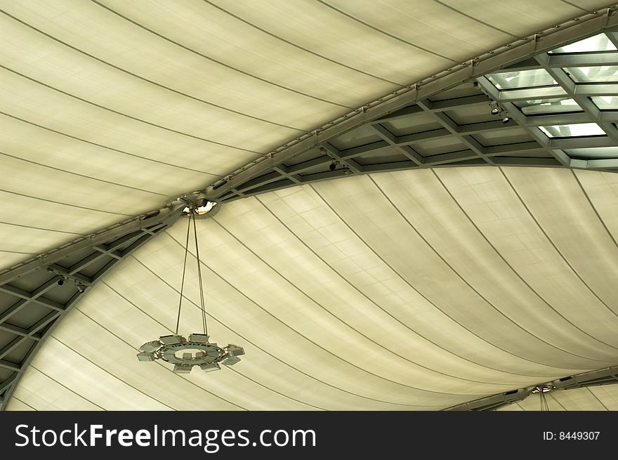 A ceiling with a lamp in an airport hall. A ceiling with a lamp in an airport hall