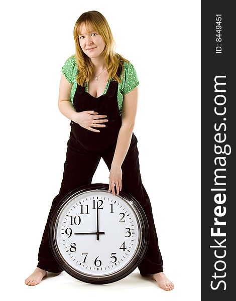 Pregnant woman with a clock on white background