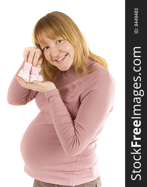 Pregnant woman holding pair of pink socks for baby girl