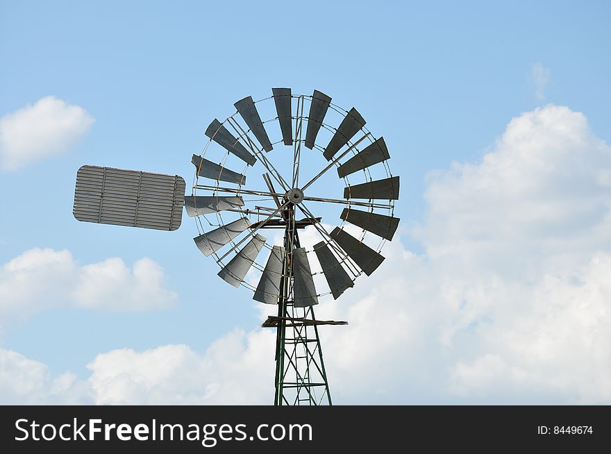 Windmill with blue sky in background. Windmill with blue sky in background