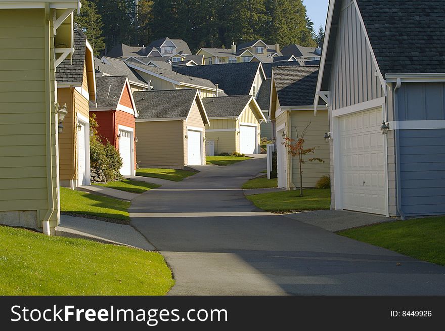 Residential neighborhood alleyway lined with colorful garages.