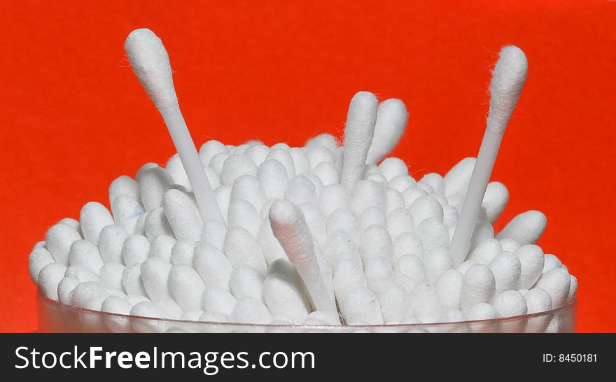 Cotton swabs on a red background