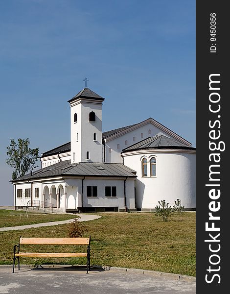 Pure white church and yellow bench. Pure white church and yellow bench