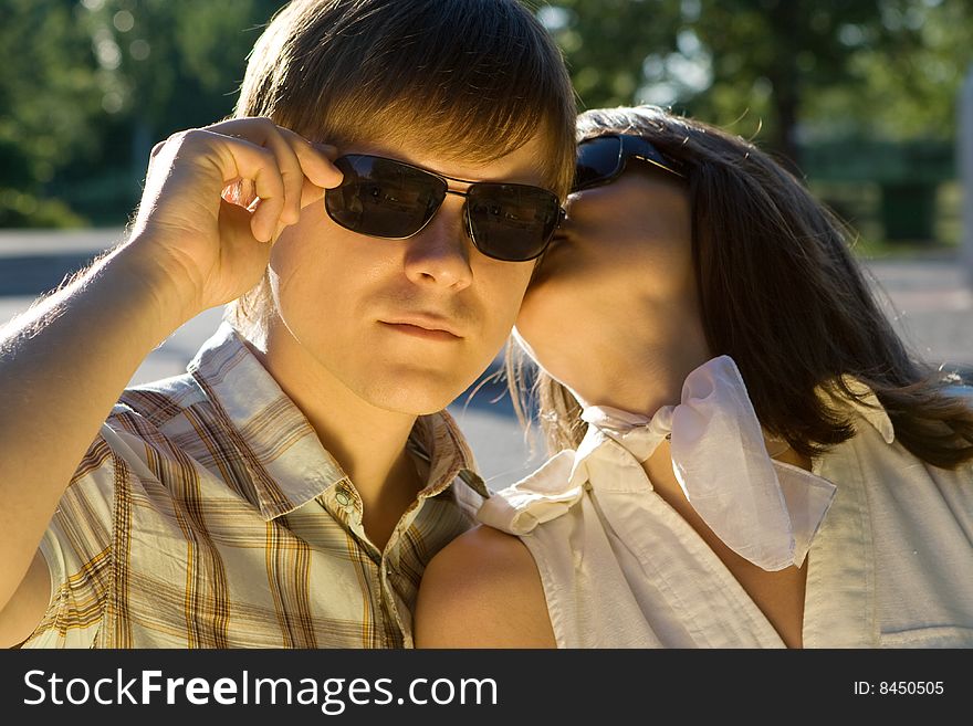 Girl Kissing A Cool Boy Who S Wearing Sunglasses