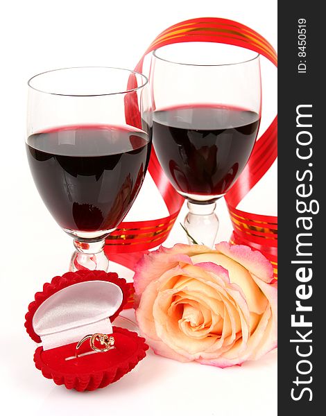 Two glasses with wine and a ring. Two glasses with wine and a ring