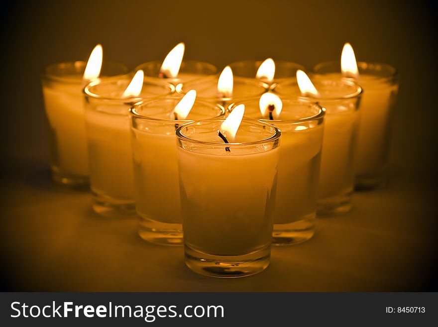 Horizontal grouping of candles in clear glass holders