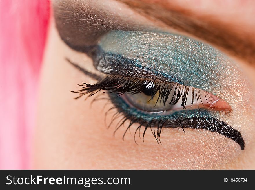 Beautiful woman's open  eye with colorful makeup