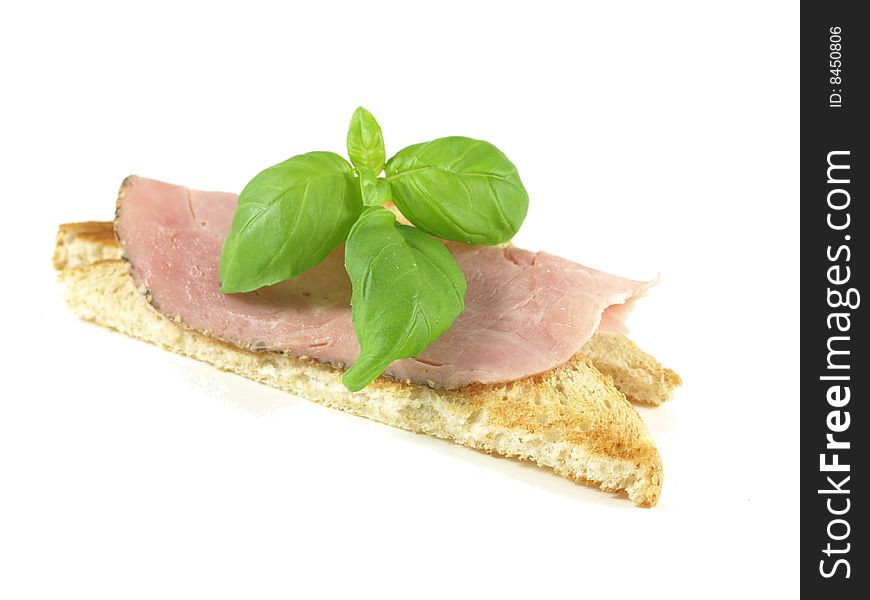 Sandwich with ham, decorated with basil on white isolated background. Sandwich with ham, decorated with basil on white isolated background.