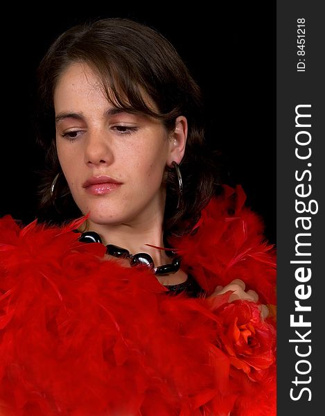 Glamorous young lady with red boa on black background, studio shot