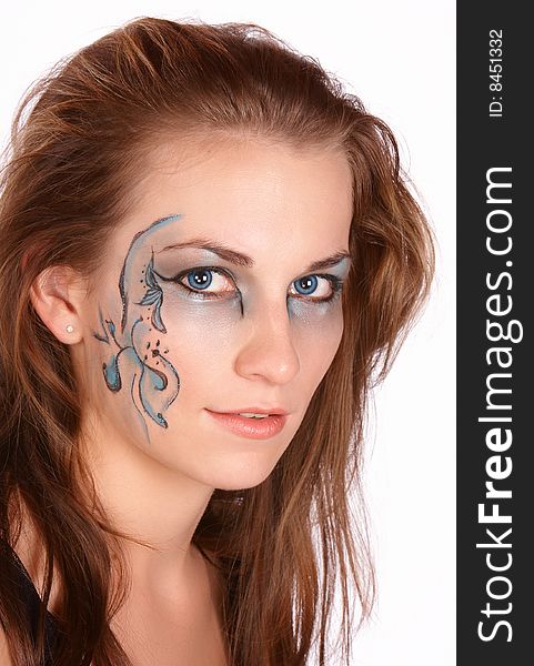 Brunette with brown hair face painted with beautiful patterns and matching eyes