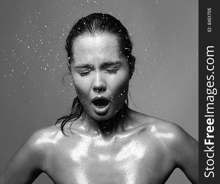 Portrait of young woman with drops of water