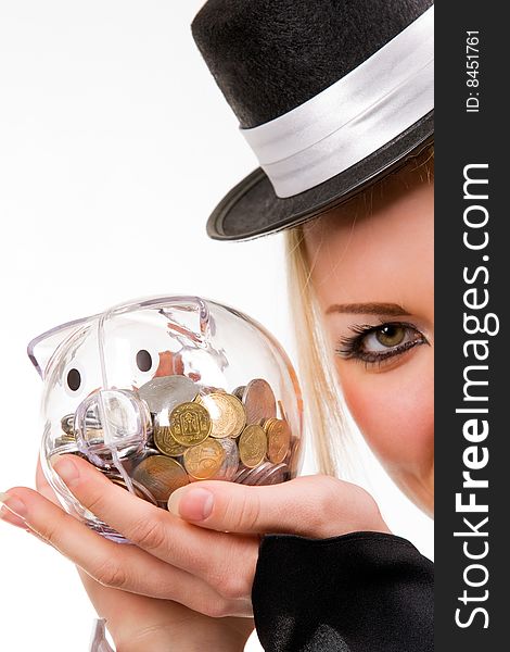 Woman holding transparent piggybank with coins. Isolated