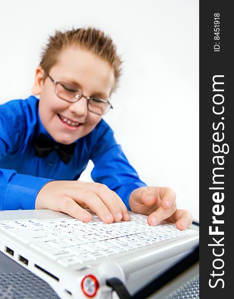 Funny school boy with laptop isolated on white