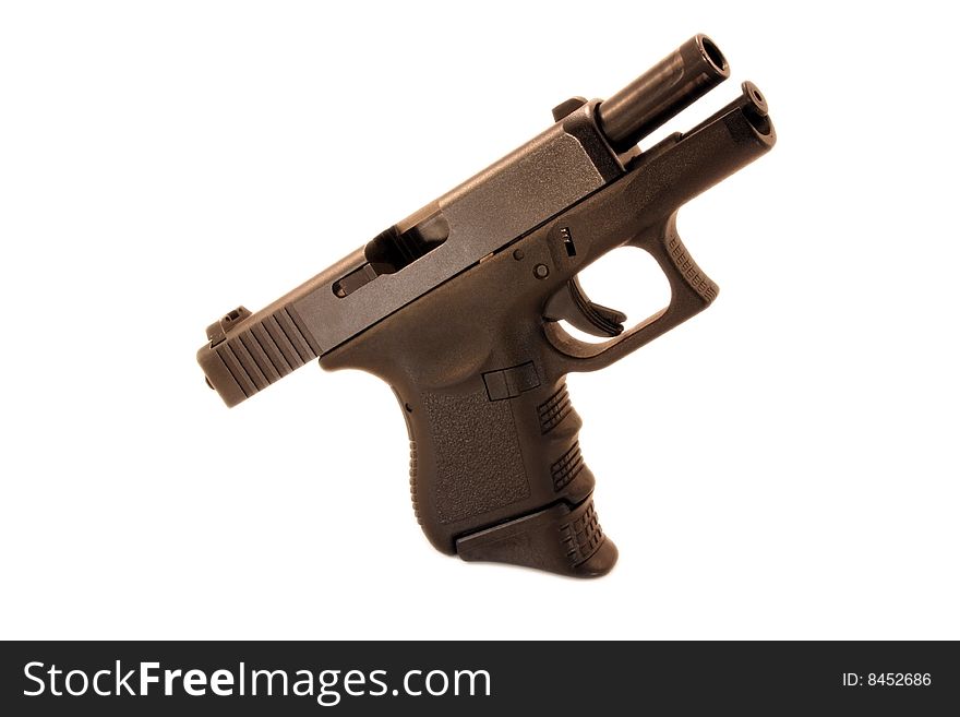 A modern day compact pistol isolated on a white background. Pistol is locked open, waiting to chamber a bullet. A modern day compact pistol isolated on a white background. Pistol is locked open, waiting to chamber a bullet.