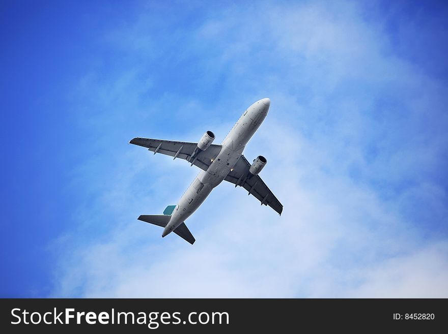 The airplane on  the blue sky background. The airplane on  the blue sky background.